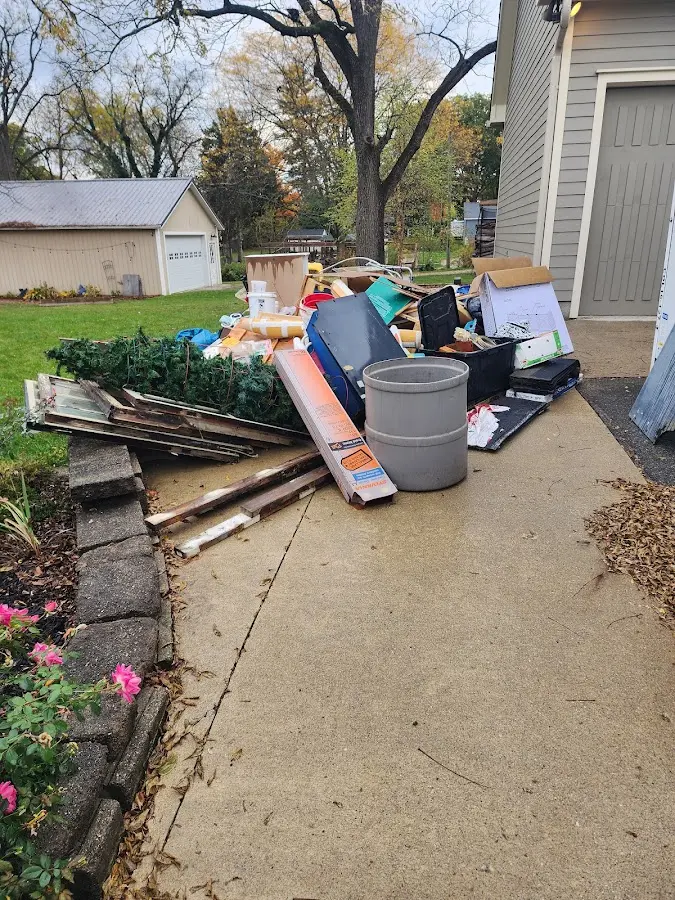Dumpster being loaded with debris for 10 Yard Dumpster Rental in Ozark